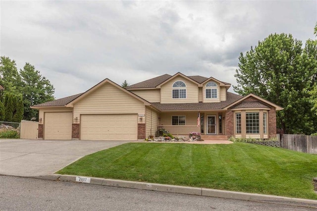 view of front of property with a front yard and a garage