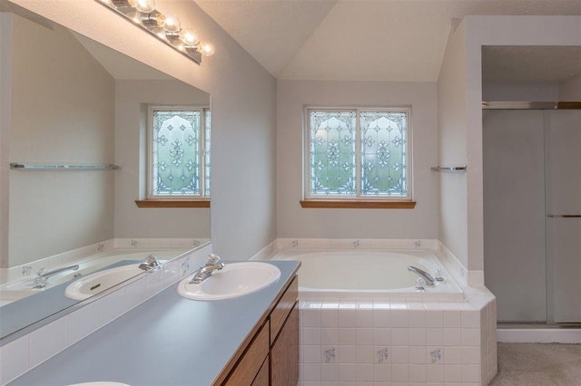 bathroom featuring a textured ceiling, lofted ceiling, plus walk in shower, and vanity