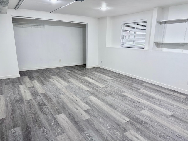 unfurnished bedroom featuring a closet and hardwood / wood-style flooring