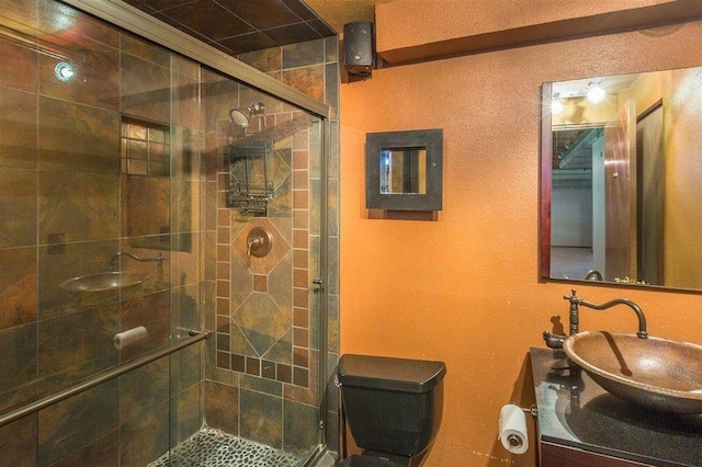 bathroom featuring walk in shower, vanity, and toilet