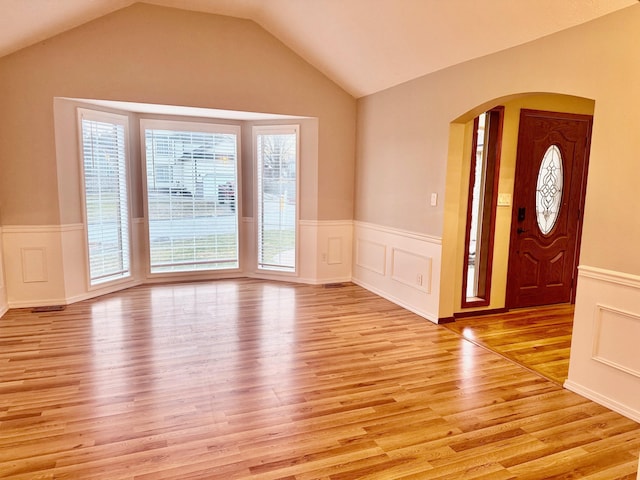 entryway with light hardwood / wood-style flooring and vaulted ceiling