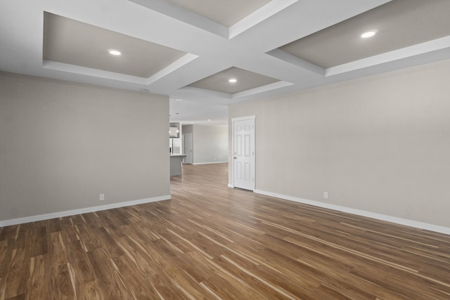 spare room featuring recessed lighting, baseboards, coffered ceiling, and dark wood-style floors