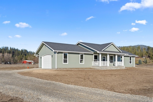 ranch-style house featuring a porch and a garage