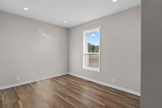 unfurnished room with recessed lighting, visible vents, baseboards, and wood finished floors