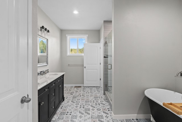 full bathroom with a soaking tub, baseboards, vanity, and a shower stall