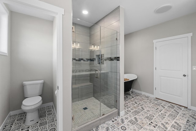 bathroom with baseboards, toilet, a stall shower, and tile patterned flooring