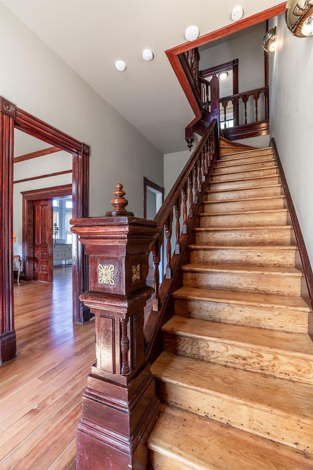 staircase with hardwood / wood-style floors