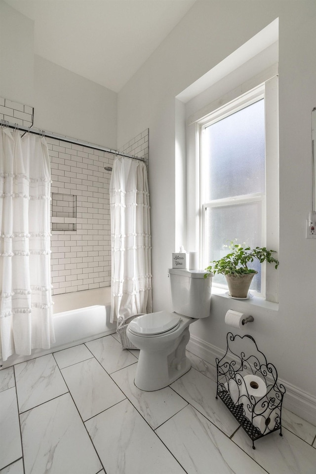 bathroom featuring toilet and shower / bathtub combination with curtain