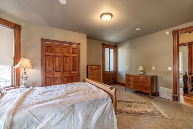 carpeted bedroom with a closet