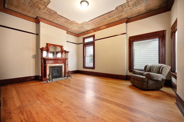 unfurnished room with ornamental molding and light wood-type flooring