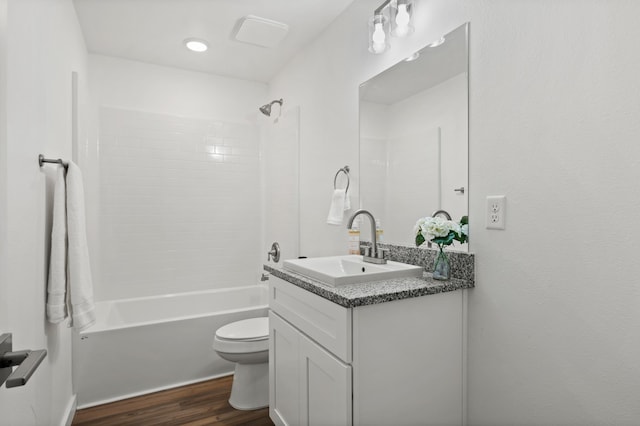 full bathroom featuring toilet, bathing tub / shower combination, wood-type flooring, and vanity