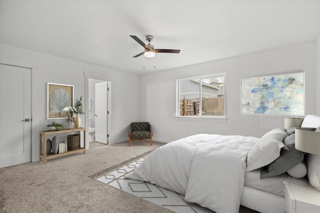 carpeted bedroom featuring ceiling fan and ensuite bathroom