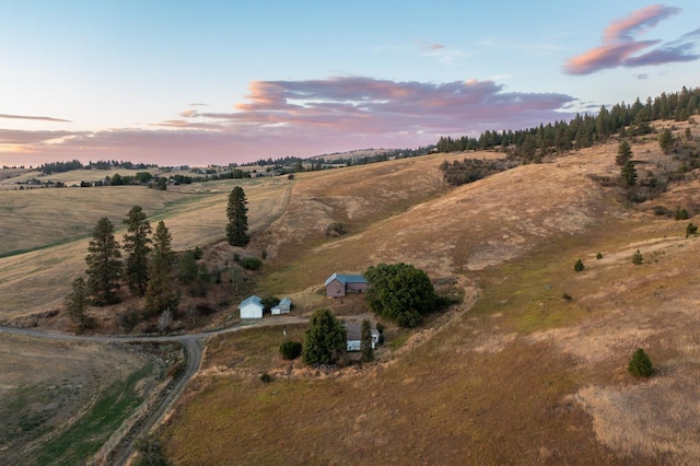 aerial view at dusk featuring a rural view