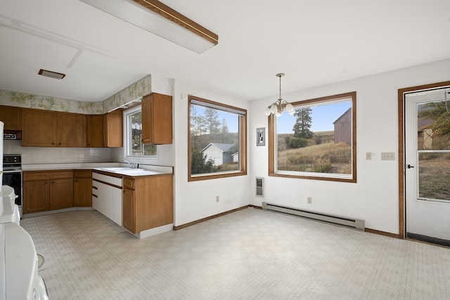 kitchen featuring decorative light fixtures, backsplash, sink, an inviting chandelier, and baseboard heating