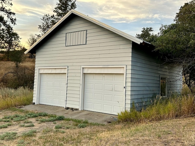 view of garage at dusk