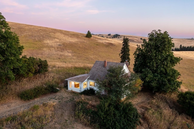 aerial view at dusk featuring a rural view