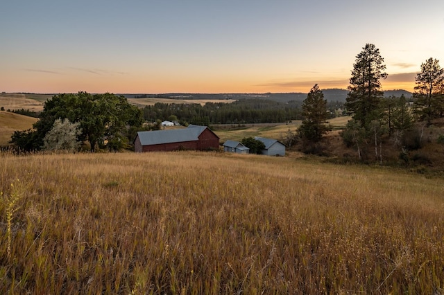 aerial view at dusk featuring a rural view