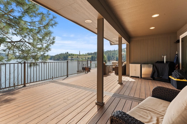 wooden terrace featuring a water view