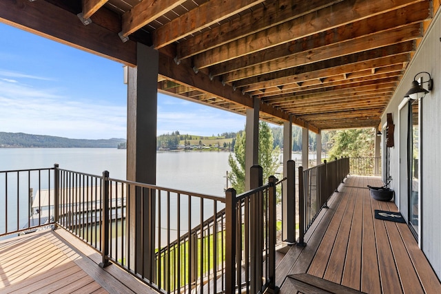 wooden deck featuring a water view