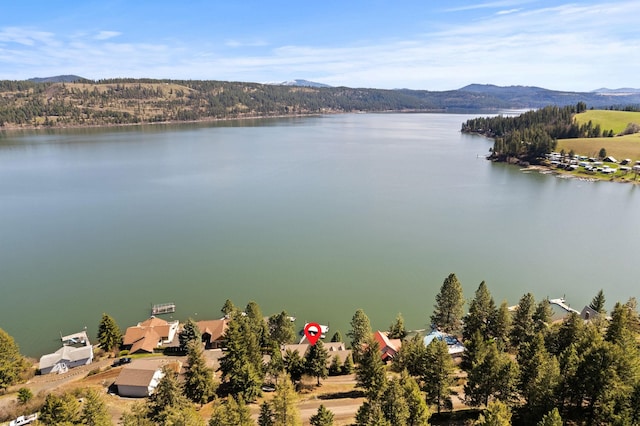 exterior space with a water and mountain view