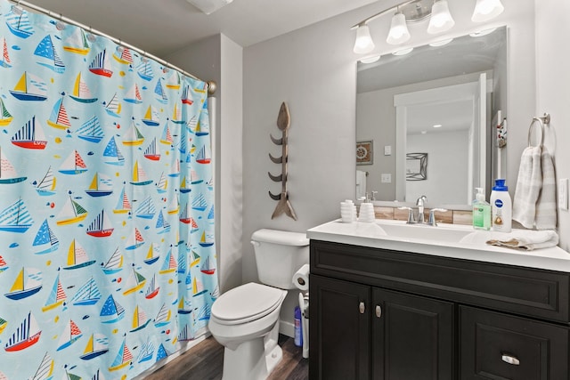 bathroom featuring toilet, vanity, a shower with shower curtain, and hardwood / wood-style flooring