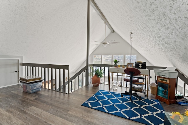 interior space with ceiling fan, hardwood / wood-style floors, a textured ceiling, and vaulted ceiling with beams