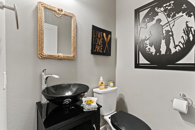 bathroom featuring toilet and vanity