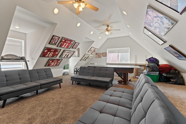 living room featuring vaulted ceiling, ceiling fan, carpet flooring, and a healthy amount of sunlight