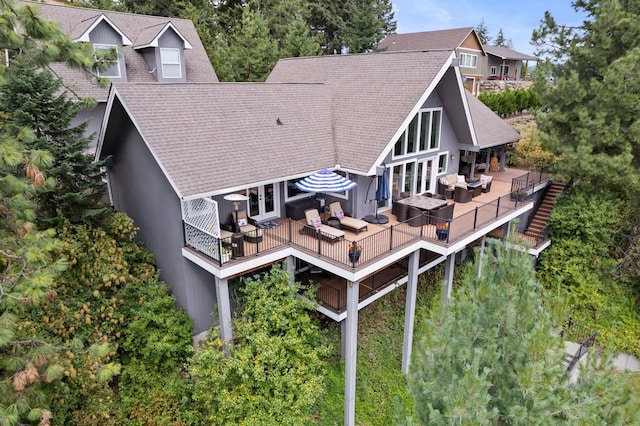 back of house with an outdoor living space and french doors