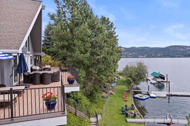 exterior space with a water view and a lawn