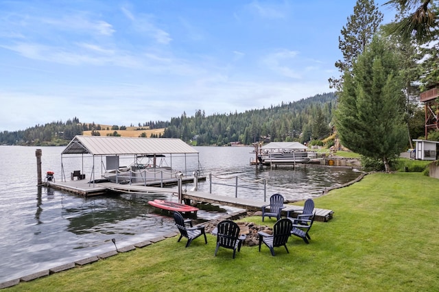 dock area with a yard and a water view