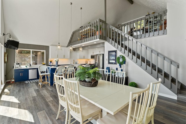 dining room featuring dark hardwood / wood-style flooring, beam ceiling, and high vaulted ceiling