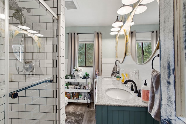 bathroom with vanity, hardwood / wood-style flooring, and an enclosed shower