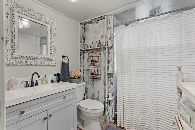 bathroom featuring toilet, vanity, a shower with curtain, and crown molding