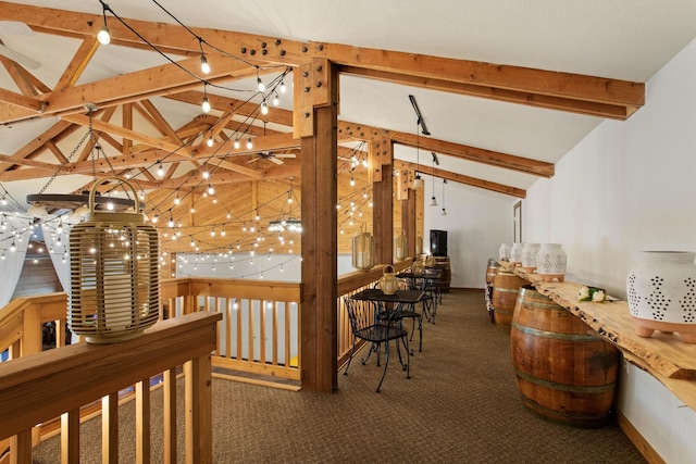 hallway with dark carpet and vaulted ceiling with beams