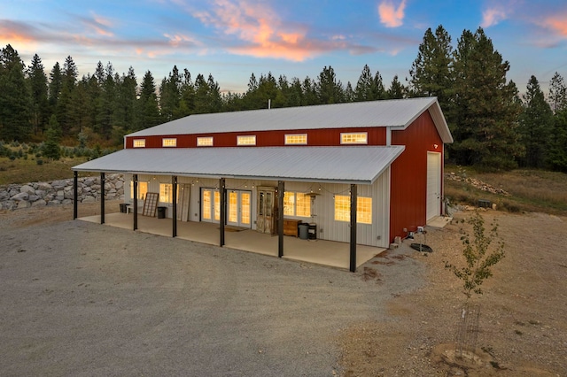 back house at dusk with a patio area