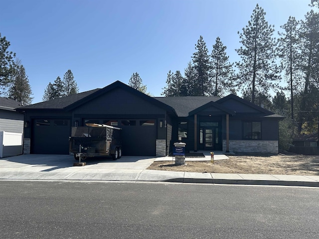 6010 N Windsor St, Spokane, WA 99208 - view of front of home with a garage, driveway, and stone siding