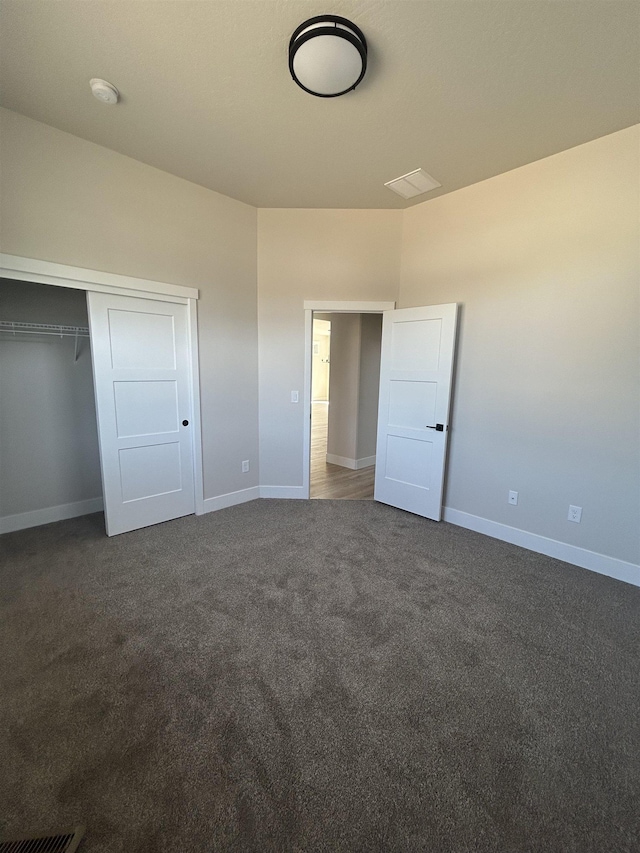 6010 N Windsor St, Spokane, WA 99208 - unfurnished bedroom with baseboards, a closet, and dark colored carpet