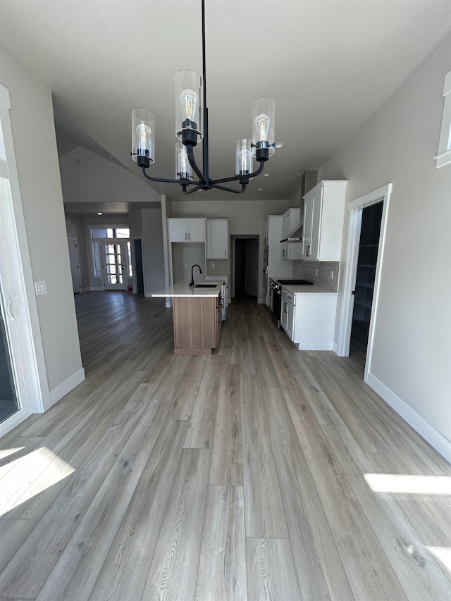 6010 N Windsor St, Spokane, WA 99208 - kitchen with baseboards, light wood-type flooring, open floor plan, and a chandelier