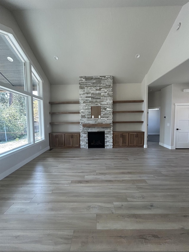 6010 N Windsor St, Spokane, WA 99208 - unfurnished living room with baseboards, light wood finished floors, and lofted ceiling