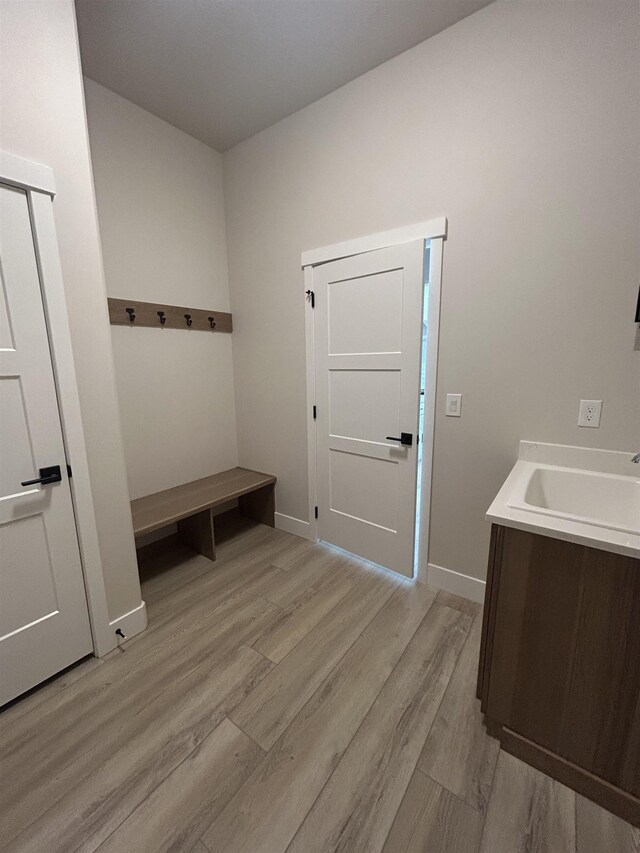 6010 N Windsor St, Spokane, WA 99208 - mudroom with baseboards, a sink, and light wood-style flooring