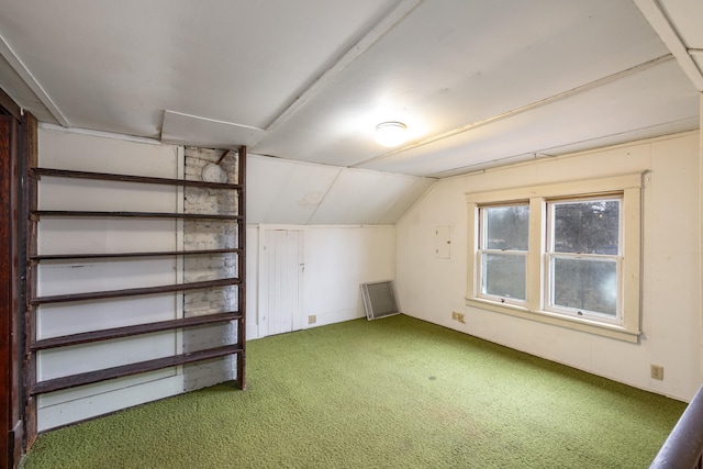 bonus room with lofted ceiling and carpet flooring