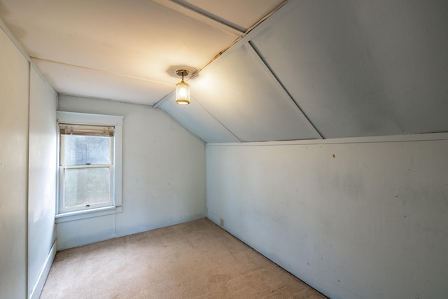 additional living space with light carpet and lofted ceiling