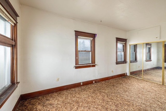 unfurnished bedroom featuring carpet floors and a closet