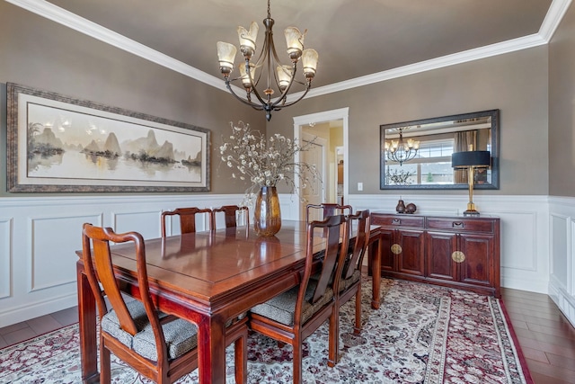 dining room featuring crown molding, a chandelier, and light wood-type flooring