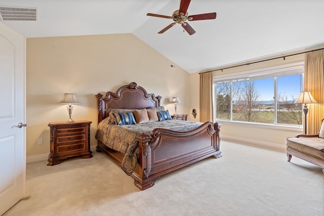 carpeted bedroom with ceiling fan and vaulted ceiling