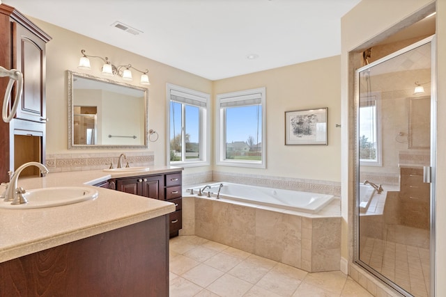 bathroom with vanity, plenty of natural light, tile patterned floors, and plus walk in shower