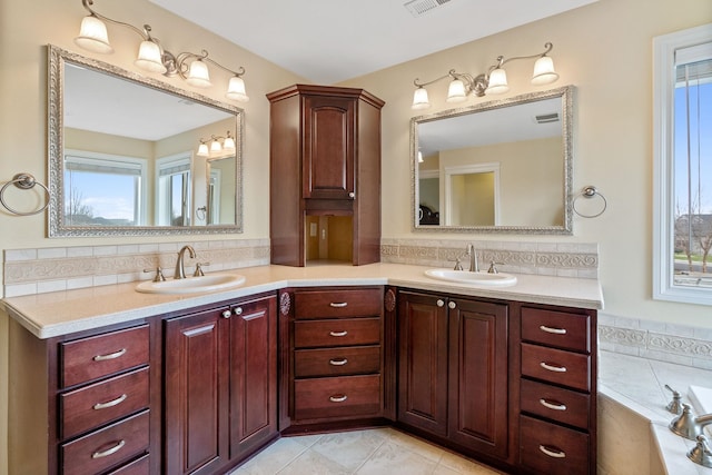 bathroom with a tub, tile patterned floors, backsplash, and vanity