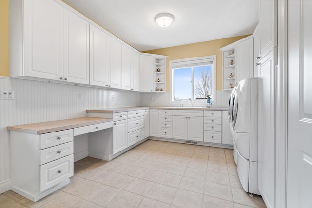 washroom with cabinets and light tile patterned floors