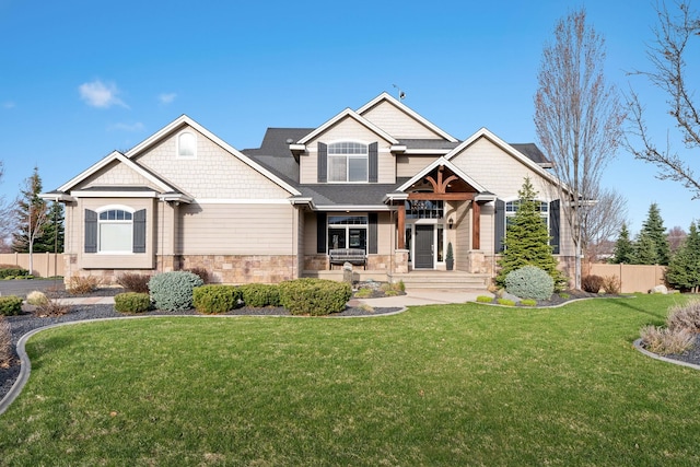 craftsman inspired home with covered porch and a front yard